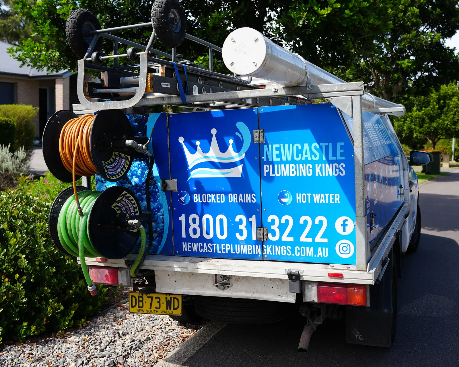 Plumbing ute parked on a residential street